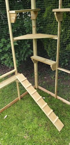 an outdoor chicken coop with steps leading up to the top and bottom part of it