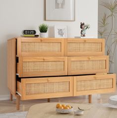 a wooden dresser with wicker drawers in a living room