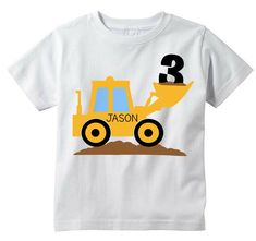 a white t - shirt with a yellow construction truck and the number three on it