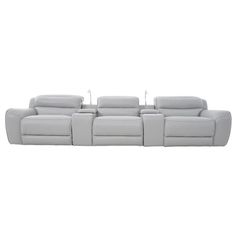 a white leather couch with four reclinings on the back and one arm extended