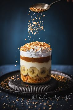 someone is sprinkling bananas on top of a dessert