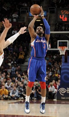 the basketball player is trying to block the ball from going up for it's basket