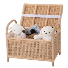 two stuffed animals sitting in a wicker basket