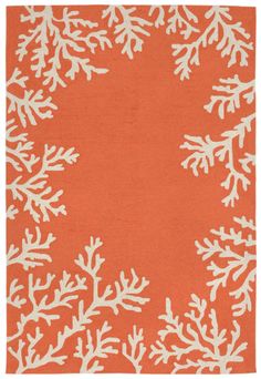 an orange rug with white snowflakes on it