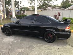 a black car is parked on the street