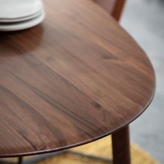 a close up view of a wooden table with plates on the plate rack in the background