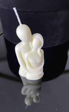 a small white sculpture sitting on top of a table