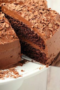 a close up of a cake on a plate with one slice taken out of it