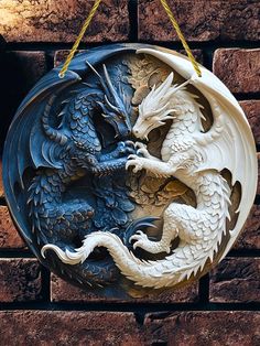 a white and blue dragon hanging on a brick wall