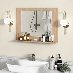 a bathroom with a sink, mirror and soap dispenser on the wall