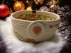 a woven basket sitting on top of a white fur covered floor next to christmas decorations