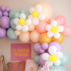 balloons and flowers are hanging from the ceiling