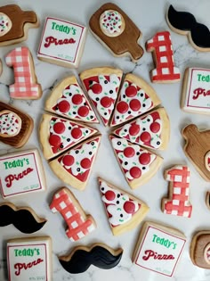 decorated cookies are arranged in the shape of pizza