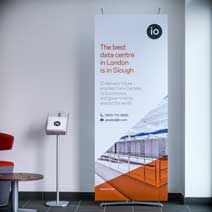 an advertisement for the london underground railway is displayed in front of a table and chairs