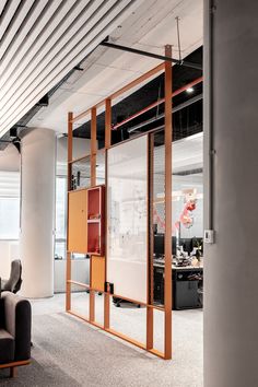 an office with glass partitions and couches