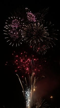 fireworks are lit up in the night sky