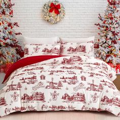 a red and white bed in a room with christmas trees