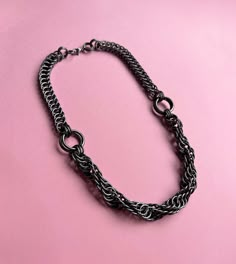 Hello!  I made this Chainmail Choker Necklace using strong & skin-friendly, hypoallergenic aluminum rings, with the ancient craft of chainmail. * This handmade jewelry will look cool & unique on your neck. (Be ready for curious questions ;) * It would be a perfect gift for a loved one, friend or a stylish family member 🎁 - Was made with the mix of Persian 4 in 1 and spiral twist chainmail patterns. - The color is Gunmetal Black - All the rings were attached to each other one by one by hand. - Limited production. - Has a stainless steel lobster clasp. HOW TO TAKE CARE OF YOUR ACCESSORY? * Anodized aluminum jump rings are treated with a special coating that helps protect the metal from scratches and corrosion, as well as giving them a vibrant color. However, even with this coating, the meta Black Chainmail, Dna Necklace, Chainmail Choker, Chainmaille Jewelry Patterns, Chainmail Patterns, Chainmail Necklace, Chainmail Jewelry, One Friend, Chain Maille Jewelry