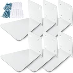 six white wall brackets with blue pins on each side and four different sized clips in the middle