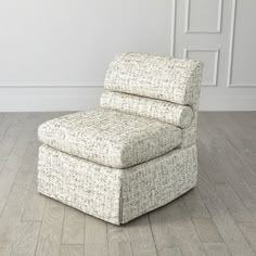 a white chair sitting on top of a hard wood floor