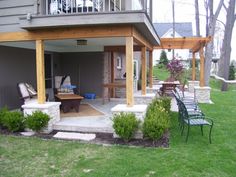 an outdoor living area with chairs and tables