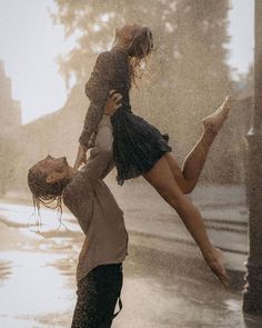 a man carrying a woman on his back in the rain