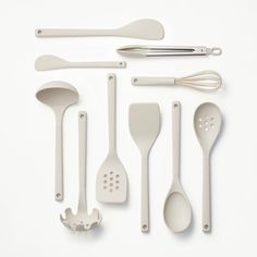 the kitchen utensils are laid out on the table with spoons and spatulas