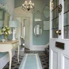 a hallway with blue walls and white furniture