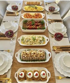 a long table is set with many dishes