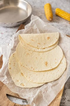 corn on the cob next to tortilla shells