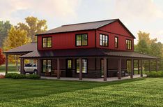 a red two story house in the middle of a green field with trees and grass