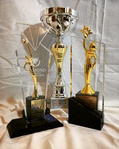 three trophies sitting on top of each other