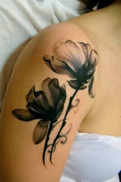 black and white flower tattoo on the arm