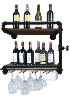 wine glasses and bottles are sitting on a wooden shelf with black pipe shelves above them