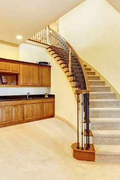 a staircase leading up to a kitchen and dining room in an empty house with no people