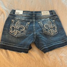 These Shorts Are Brand New With Tags Attached Authentic Beautiful Embellishments On The Back Pockets As Usual Jean Short, Y2k Denim Blue Shorts With Pockets, Y2k Medium Wash Mid-rise Jean Shorts, Y2k Denim Bottoms With Built-in Shorts, Y2k Denim Jean Shorts With Built-in Liner, Y2k Denim Jean Shorts With Built-in Shorts, Miss Me Shorts, Ed Hardy, Miss Me