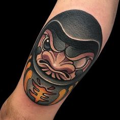 a man's arm with a tattoo on it that has an image of a helmet and flames