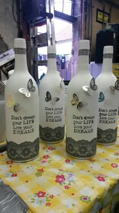 three empty bottles sitting on top of a table