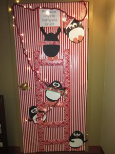 a door decorated with penguins and christmas lights