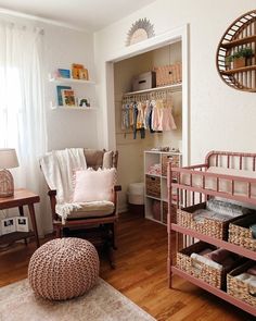 a baby's room with a pink crib in the corner and lots of storage