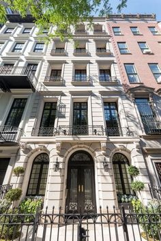 an apartment building with many windows and balconies on the front, in new york city