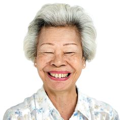 an older woman smiling with her eyes closed and white hair in front of her face