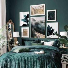 a bedroom with green walls and pictures on the wall above it, along with a bed