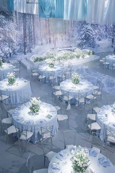 tables and chairs are set up in the middle of a snow - covered area for an event