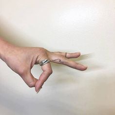 a person's hand with a ring on it