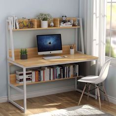 a desk with a computer on top of it next to a chair and bookshelf