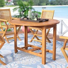 a wooden table with four chairs around it