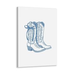 a blue and white drawing of cowboy boots on a white background canvas wall art print