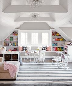 a living room filled with furniture and a white ceiling mounted book shelf next to a window