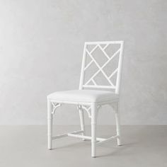 a white chair sitting on top of a gray floor